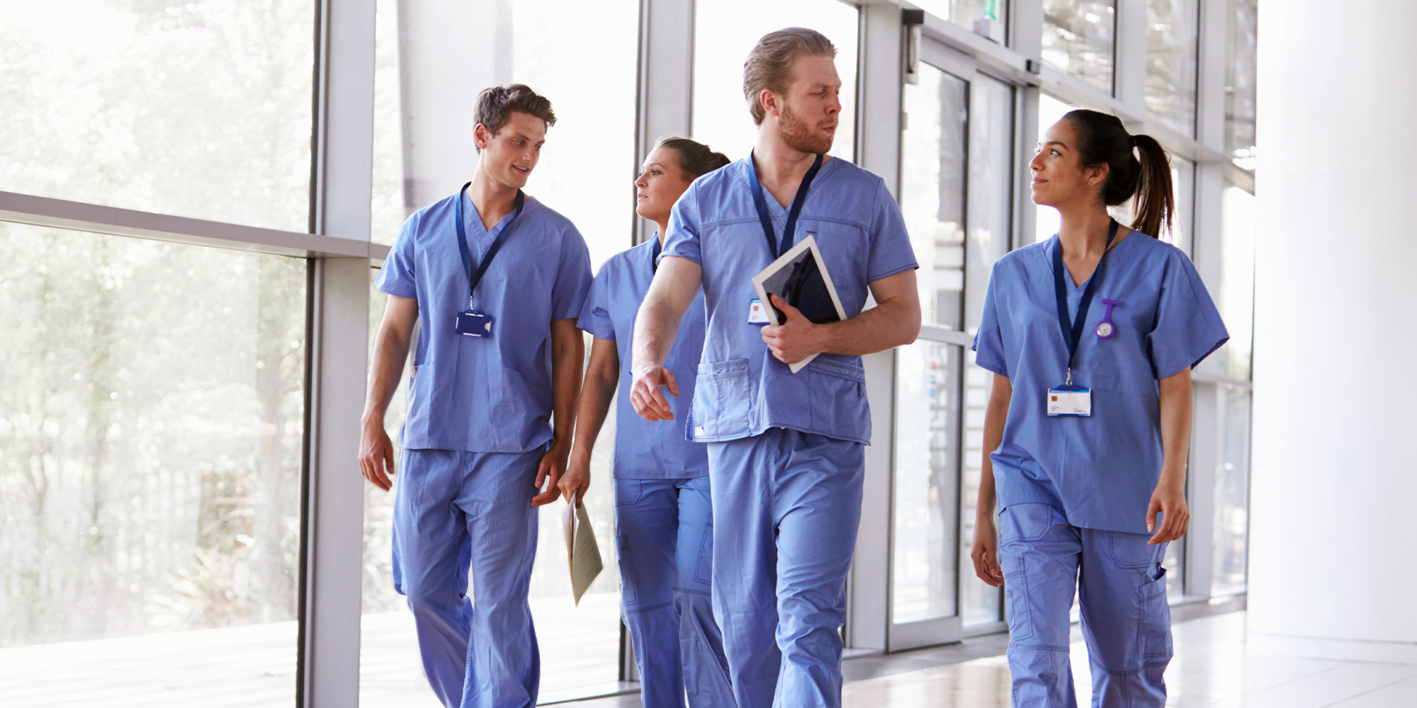 Group of nurses walking through a facility
